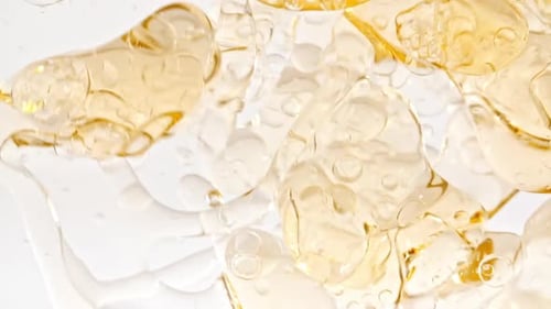 Liquid with Bubbles Moving in Macro Shot