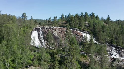 Drone Flying Over Tall Trees and a Rocky Water Falls
