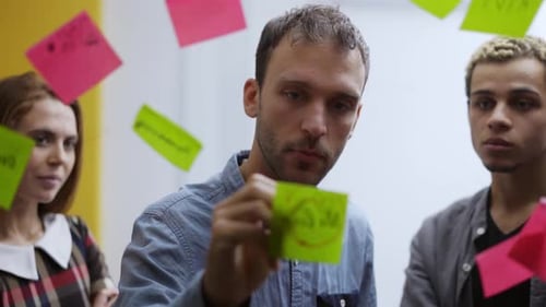 Diverse Group of Finance Office Worker Having Corporate Training and Using Glass Wall with Stickers