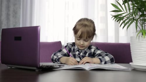 Little Girl Doing Homework Indoors at Home