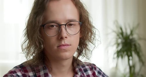 Young Adult Wearing Glasses Looking at Camera