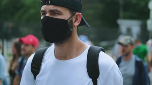 Young Adult Wearing Mask Walking in City