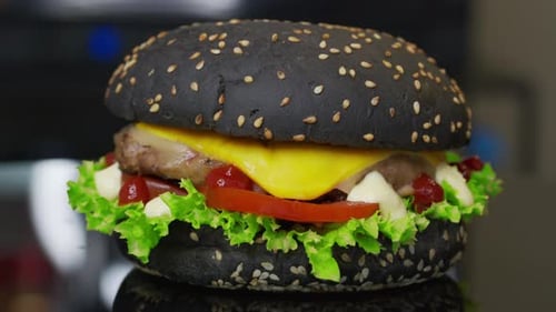 Black Bun Burger Close Up with Ingredients