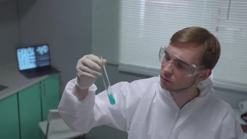 Scientist Examining Test Tube in Laboratory Setting
