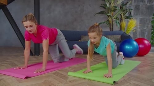 Woman and Child Exercise Together at Home