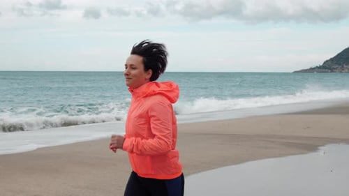 Girl is running on sandy beach