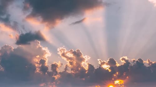 Golden Sunlight Through Dramatic Clouds at Sunset