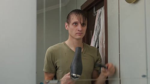 Man Dries His Hair in the Bathroom