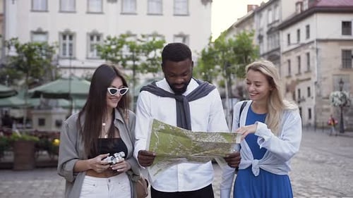 Friends Explore a European City with Map and Camera