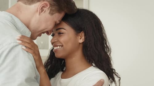 Affectionate Couple Embracing with Foreheads Together