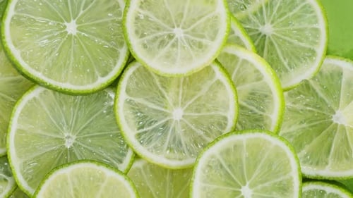 Green Limes Rotating Top View Fresh and Ripe Citrus Fruits Circles