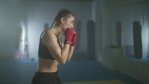 Caucasian Woman Fighter Trains His Punches and Defense in the Boxing Gym a Boxer Trains in Front of