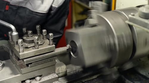 Metal Being Cut on Lathe in Factory
