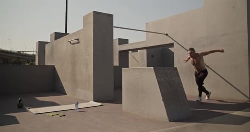 Athletic Man Doing Parkour Training Outdoors