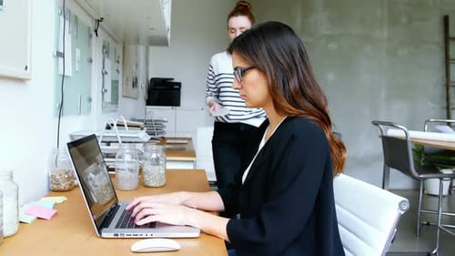 Women Collaborate in a Modern Office Environment