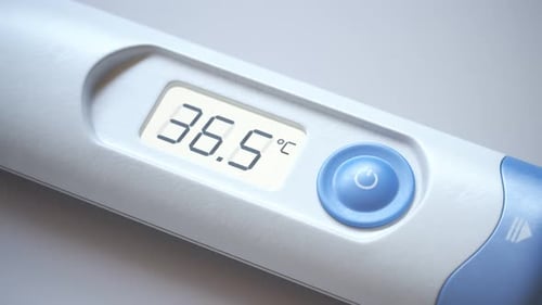 Closeup view at a thermometer with rising temperature value. Fever, flu. 4KHD