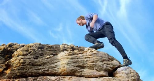 Male hiker raising hands on the top of mountain 4k