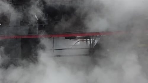 A retro steam locomotive leaves the station.