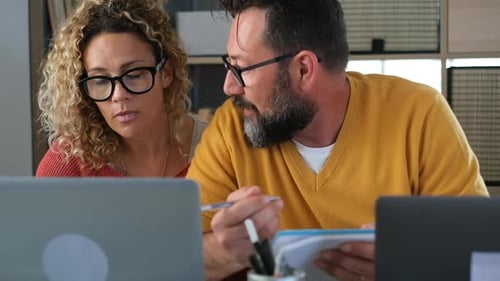 Colleagues Collaborating with Laptops in Bright Room