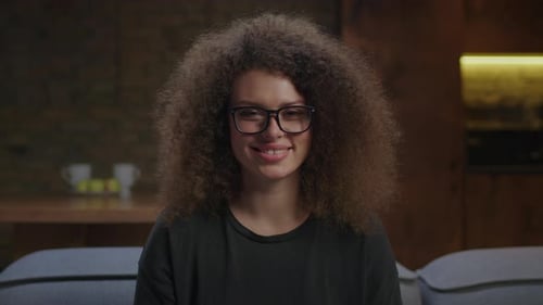 Woman Smiling at Camera Indoors