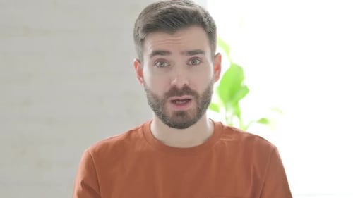 Man Celebrates With Fists Pumped, Smiling