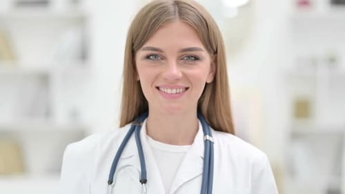Friendly Woman Doctor Smiling in Hospital Office