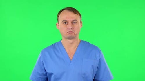 Medical Man Listens Carefully Information and Nods Head. Green Screen