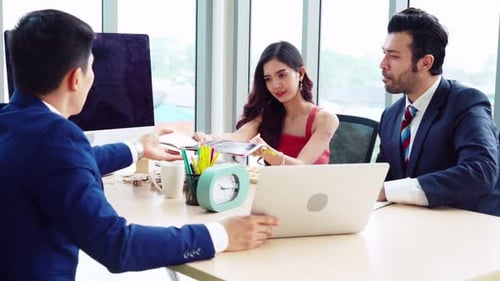Team Discussing Business Proposal in Bright Office