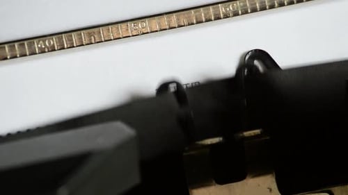 Vintage Typewriter Types the Word "INVITATION"