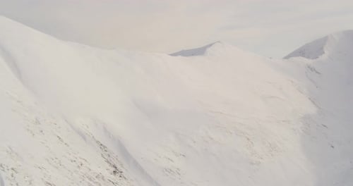 Aerial helicopter shot of valley at golden hour, fly in closer towards a bridge, tire tracks, drone