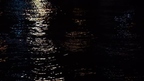 Shimmering Water Reflects City Lights at Night