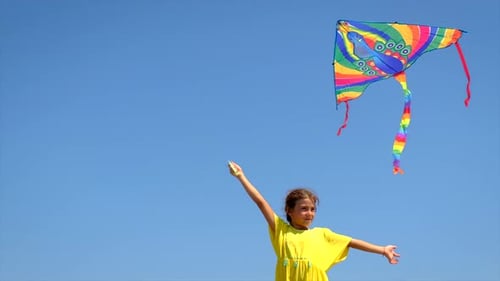 Girl Flying Kite on Sunny Day at the Beach