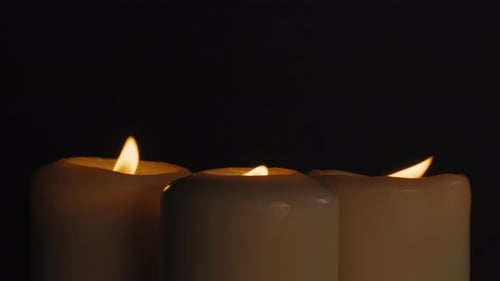 Burning Wax Candles on Black Chroma Key Background