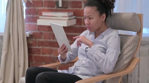 Woman Using Tablet in Modern Chair