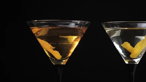 Elegant Martini Glasses with Lemon Twist on Black