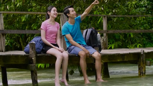 Asian Couple Hikers Looking At The View