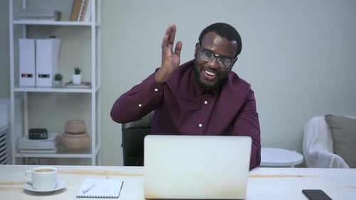 Man Waving During Video Conference