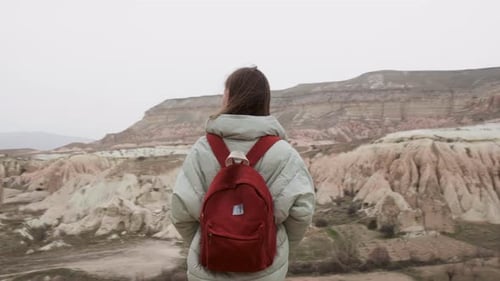Happy Backpacker Girl Enjoying Beautiful Canyon Scenery and Bizarre Rock Formations in Rose Valley
