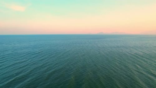 4K Aerial view of drone move on beautiful sea. sunset over ocean waves sand beach.