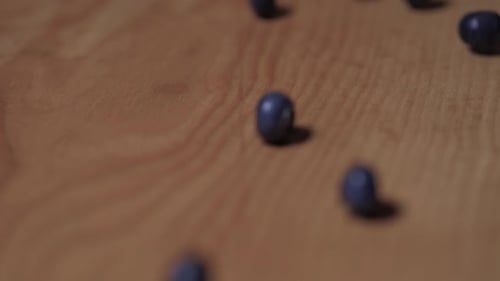 Fresh Blueberries Falling on Wooden Surface