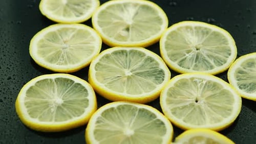Close-Up of Fresh Lemon Slices on Black Background