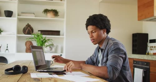 Man Uses Phone While Working From Home