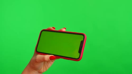 Woman Holds Mobile Phone with Workspace Mock Up Screen in Her Hands on Green Background in