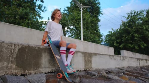 Thoughtful Skater Guy on Urban Background
