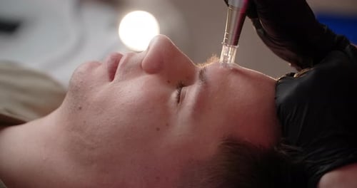 Man Receiving Microblading Treatment Close Up