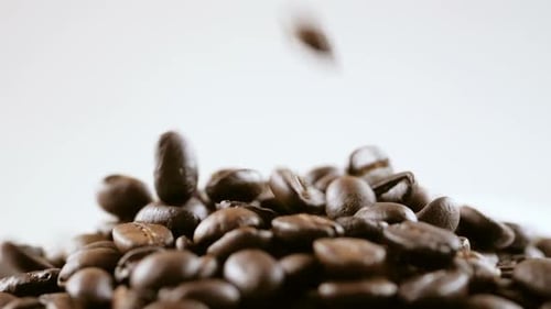 Coffee Beans Drop Onto Pile