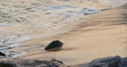 Sea Wave on Beach at Sunset