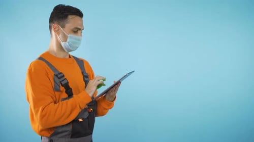 Handyman with Tablet Isolated on Blue Backgound with Copy Space Studio Shot