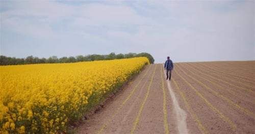 Agriculture Farmer Walking on Field.