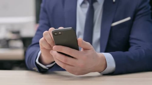 Hand Close Up of Businessman Using Smartphone